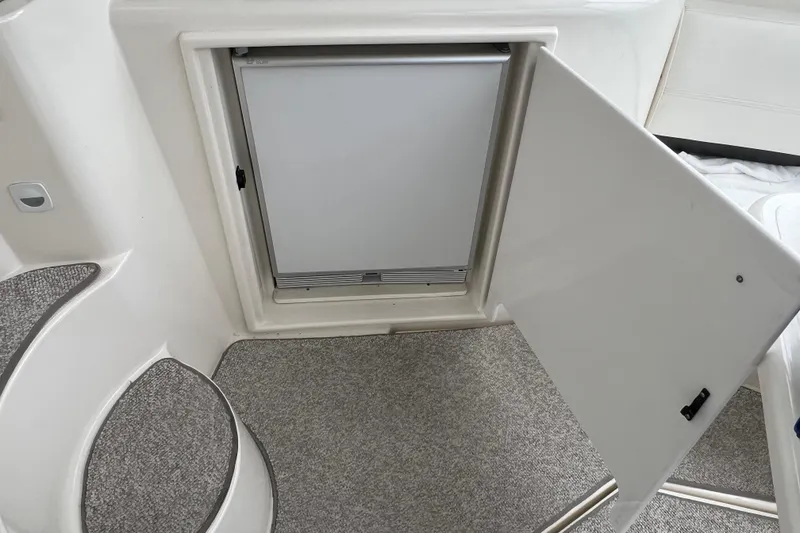 Slide: The Image of 2005 Cruisers Yachts 400 Express interior with open fridge and carpeted steps. - 17