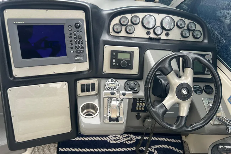 Slide: The Image of 2005 Cruisers Yachts 400 Express dashboard with steering wheel and navigation controls. - 18