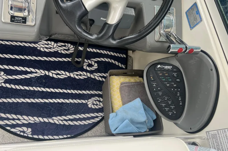 Slide: The Image of 2005 Cruisers Yachts 400 Express helm with steering wheel and control panel. - 19