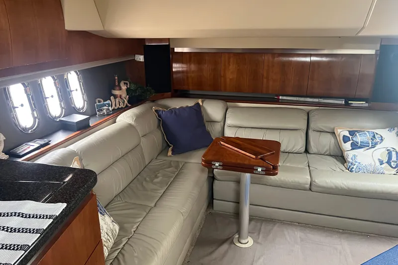Slide: The Image of Interior of 2005 Cruisers Yachts 400 Express with leather seating and wooden accents. - 21