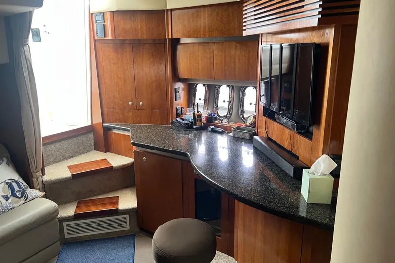 Slide: The Image of Interior of 2005 Cruisers Yachts 400 Express with wood cabinetry and modern amenities. - 22