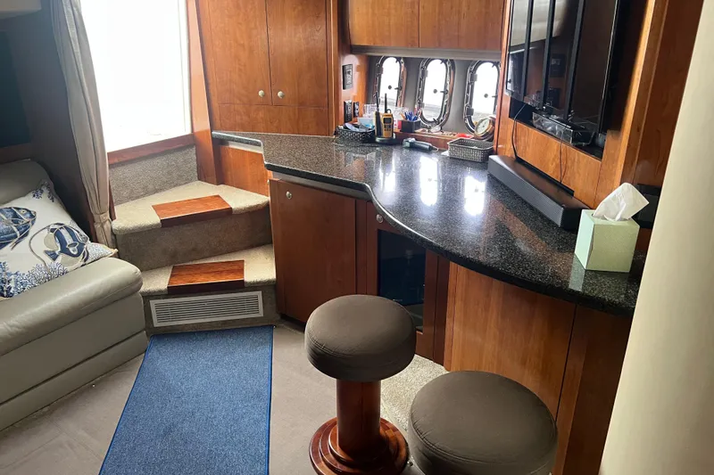 Slide: The Image of Luxurious interior of 2005 Cruisers Yachts 400 Express with elegant wood finishes and seating. - 23