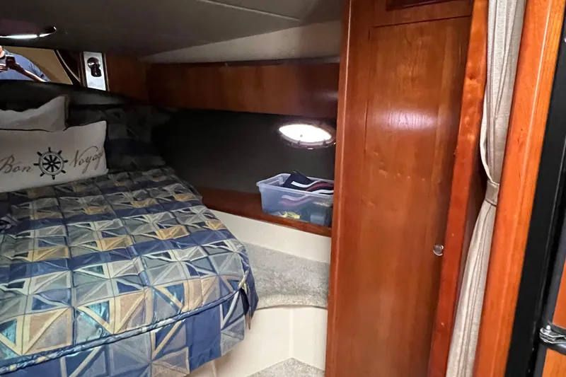 Slide: The Image of 2005 Cruisers Yachts 400 Express cabin interior with bed and wooden cabinetry. - 30