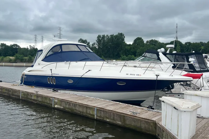 Slide: The Image of 2005 Cruisers Yachts 400 Express docked on a cloudy day. - 7