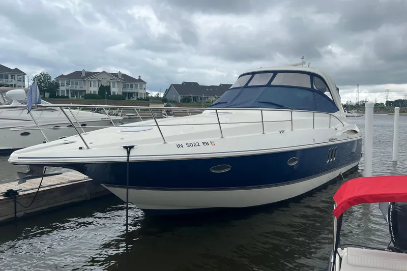 Slide: The Image of 2005 Cruisers Yachts 400 Express docked, featuring sleek design and blue accents. - 8