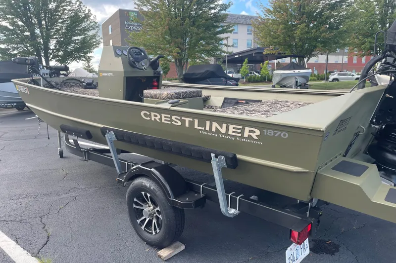 Slide: The Image of 2024 Crestliner 1870 Retriever FCC boat on trailer, parked outdoors. - 3