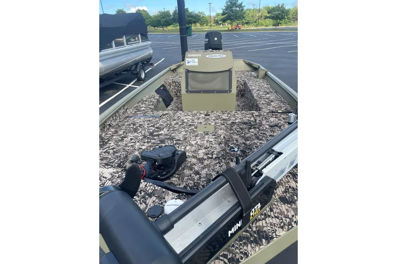 Slide: The Image of 2024 Crestliner 1870 Retriever FCC boat with camo interior in parking lot. - 4