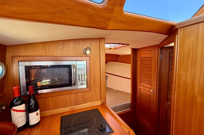 Slide: The Image of Luxurious interior of 2002 Palm Beach Motor Yachts Avalon 38 with wood finish and modern amenities. - 11