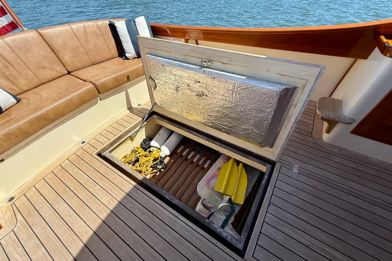 Slide: The Image of Open storage compartment on 2002 Palm Beach Motor Yachts Avalon 38, featuring teak deck and seating. - 14