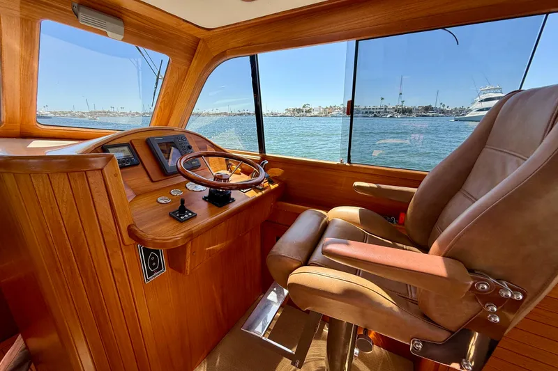 Slide: The Image of Luxurious helm of 2002 Palm Beach Motor Yachts Avalon 38 with leather captain's chair. - 17