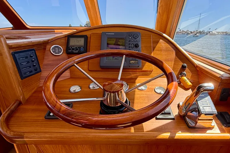 Slide: The Image of Steering wheel and controls of 2002 Palm Beach Motor Yachts Avalon 38, with navigation instruments. - 18