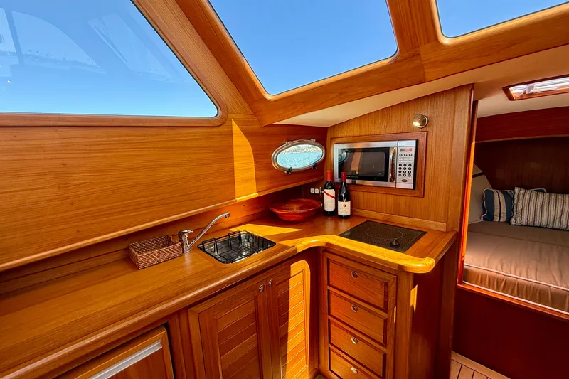 Slide: The Image of Luxurious wooden interior of 2002 Palm Beach Motor Yachts Avalon 38, featuring kitchenette and cozy cabin. - 19