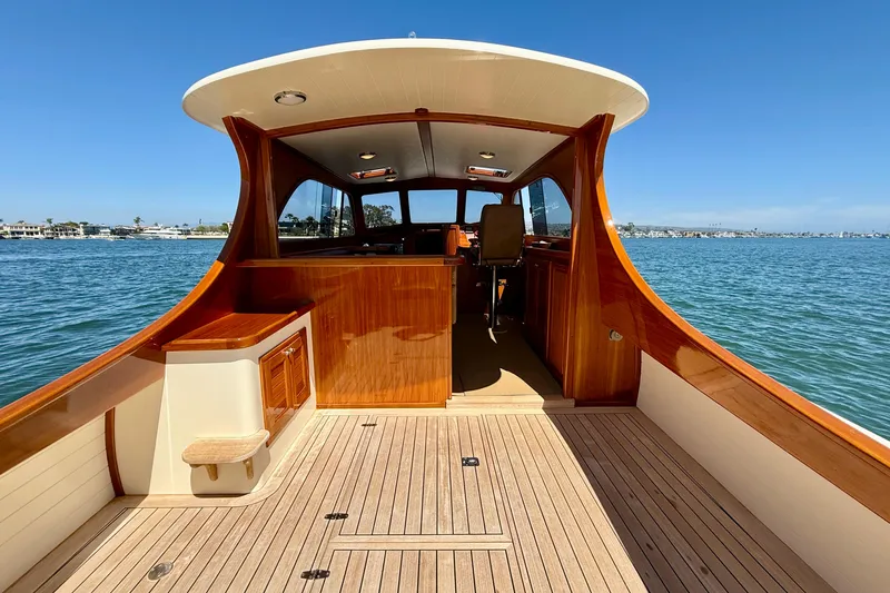 Slide: The Image of 2002 Palm Beach Motor Yachts Avalon 38, elegant wooden deck, scenic waterfront view. - 24