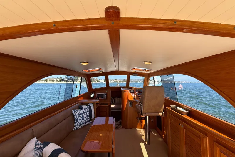 Slide: The Image of Interior of 2002 Palm Beach Motor Yachts Avalon 38, featuring elegant wood finish and scenic water view. - 25