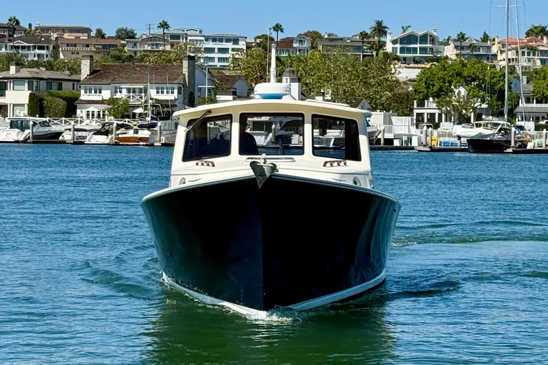 Slide: The Image of Front view of 2002 Palm Beach Motor Yachts Avalon 38 cruising in a marina. - 30