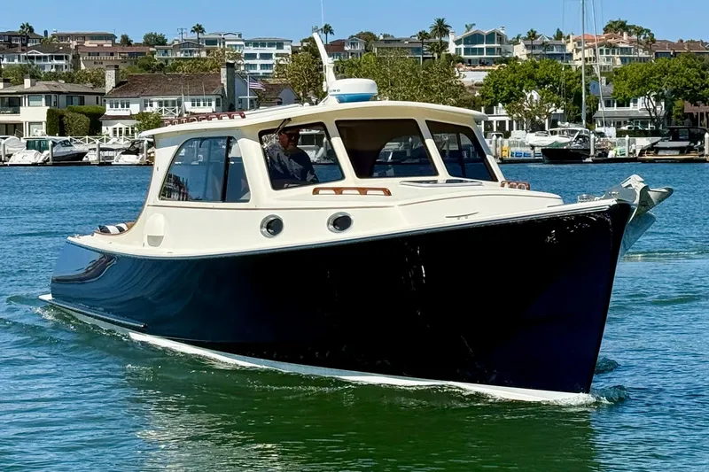 Slide: The Image of 2002 Palm Beach Motor Yachts Avalon 38 cruising in a scenic marina setting. - 31