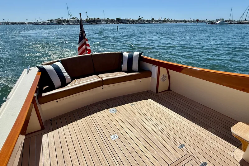 Slide: The Image of 2002 Palm Beach Motor Yachts Avalon 38, elegant deck with seating, American flag, ocean view. - 36