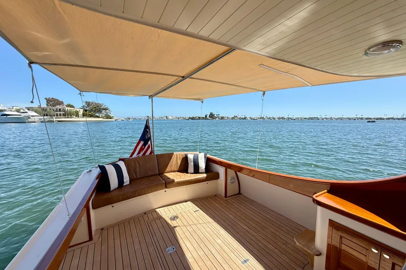 Slide: The Image of Luxurious 2002 Palm Beach Avalon 38 yacht with shaded deck and scenic water view. - 37