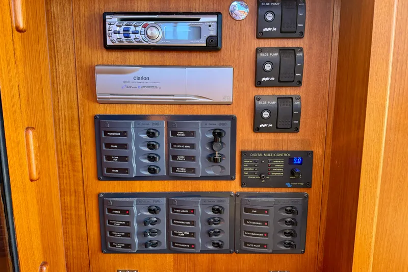 Slide: The Image of Control panel of 2002 Palm Beach Motor Yachts Avalon 38 with audio system and switches. - 38