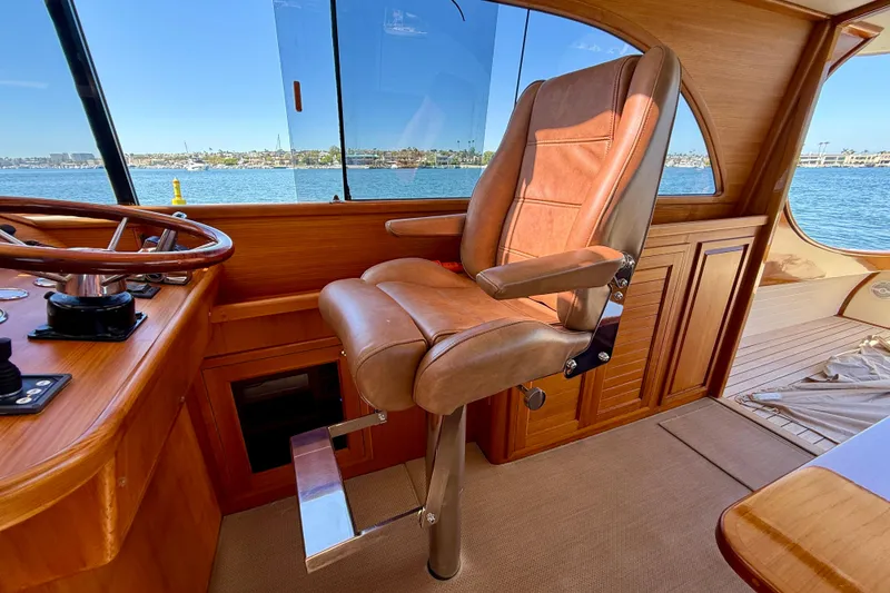 Slide: The Image of Luxurious helm seat on 2002 Palm Beach Motor Yachts Avalon 38, overlooking serene waters. - 39
