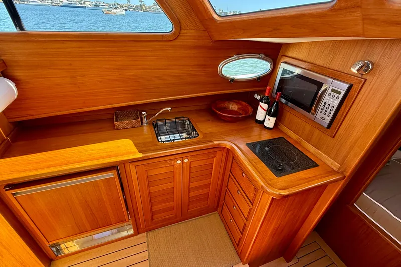Slide: The Image of Luxurious wooden interior of 2002 Palm Beach Motor Yachts Avalon 38 galley with modern amenities. - 40