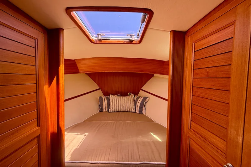 Slide: The Image of Luxurious cabin interior of 2002 Palm Beach Motor Yachts Avalon 38 with skylight and wood finish. - 6