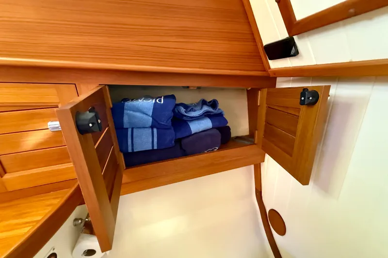 Slide: The Image of Wooden cabinet with towels inside on a 2002 Palm Beach Motor Yachts Avalon 38. - 9