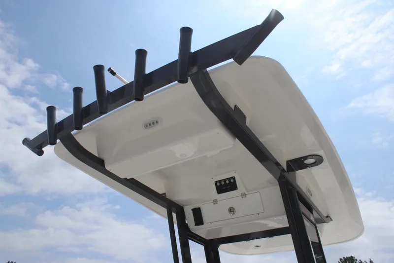 Slide: The Image of 2026 Sea Fox 248 Commander boat top view with rod holders against a blue sky. - 11