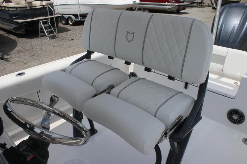 Slide: The Image of 2026 Sea Fox 248 Commander boat interior with white cushioned seating and steering wheel. - 12