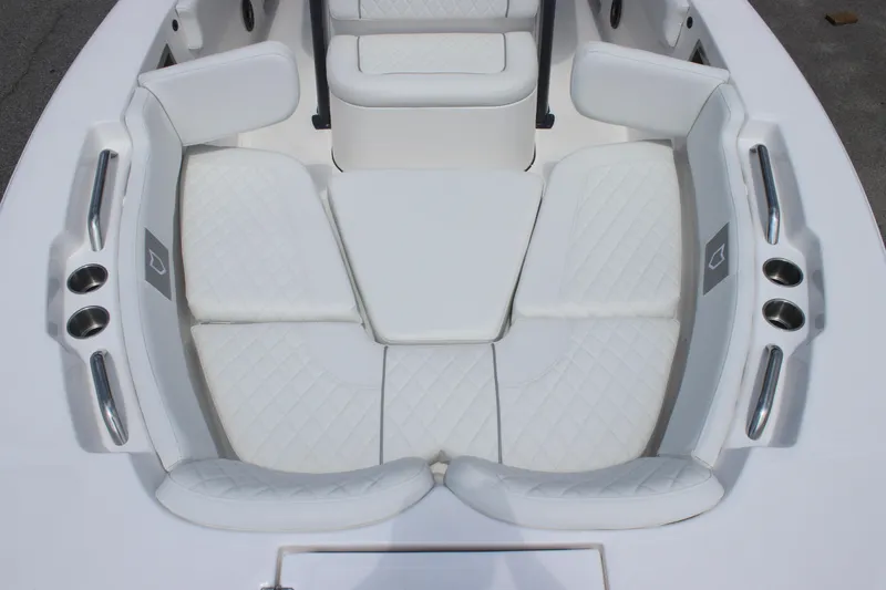 Slide: The Image of 2026 Sea Fox 248 Commander boat interior with white cushioned seating and cup holders. - 26