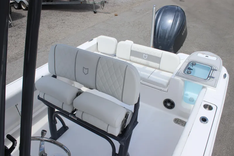Slide: The Image of 2026 Sea Fox 248 Commander boat interior with cushioned seating and outboard motor. - 28