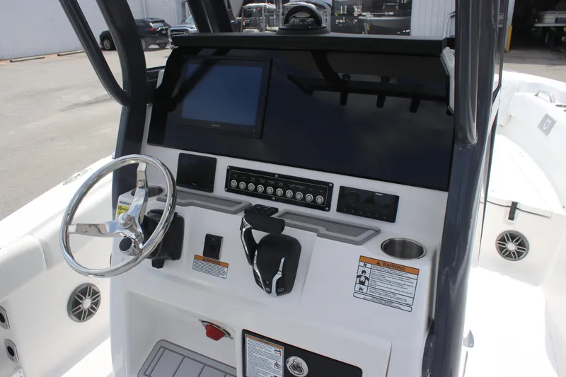 Slide: The Image of 2026 Sea Fox 248 Commander boat dashboard with steering wheel and control panel. - 8
