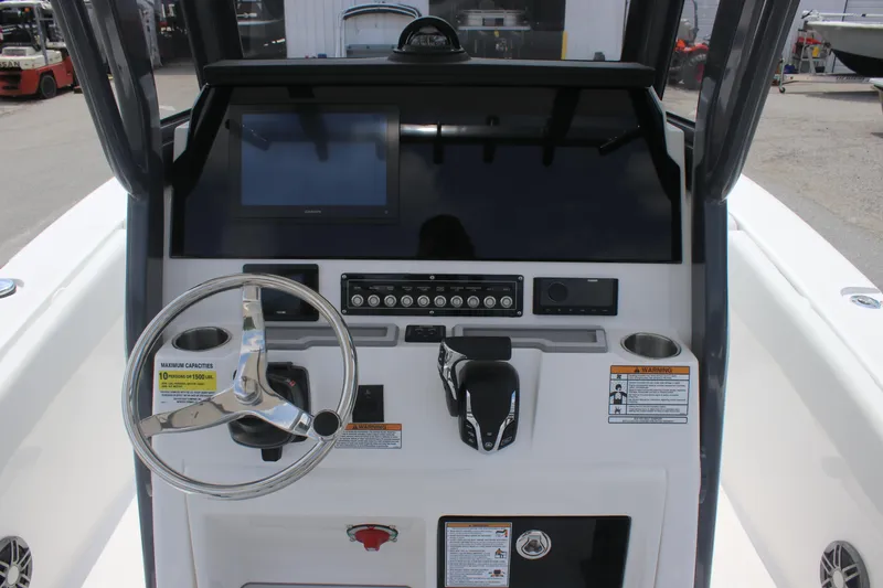 Slide: The Image of 2026 Sea Fox 248 Commander boat dashboard with steering wheel and control panel. - 9