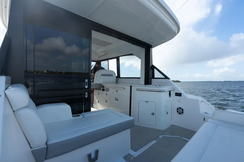 Slide: The Image of 2022 Regal 36 XO yacht interior with seating and ocean view. - 1