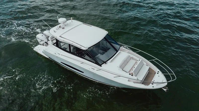 Slide: The Image of 2022 Regal 36 XO boat cruising on open water. - 10