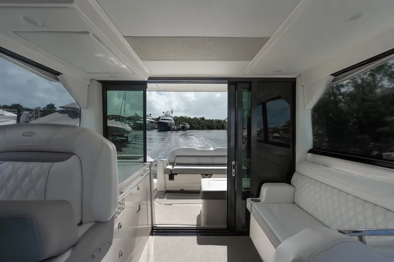 Slide: The Image of Interior view of 2022 Regal 36 XO yacht with luxurious seating and water view. - 17