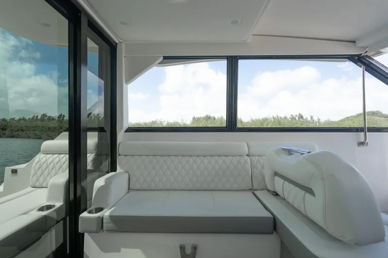 Slide: The Image of Luxurious interior of 2022 Regal 36 XO yacht with plush seating and panoramic windows. - 19