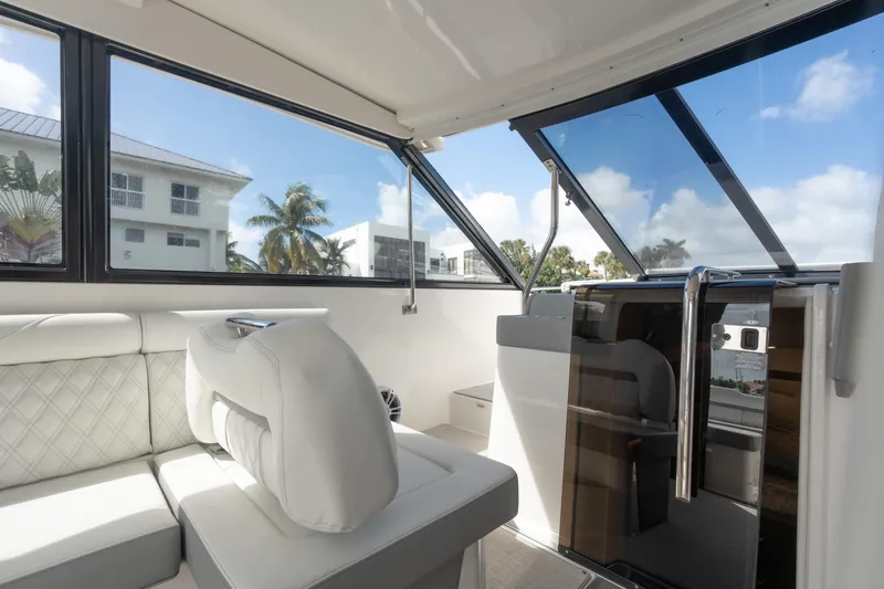 Slide: The Image of Interior of 2022 Regal 36 XO yacht with white seating and large windows. - 20