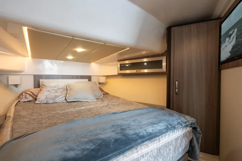 Slide: The Image of Luxurious cabin interior of 2022 Regal 36 XO yacht with cozy bedding. - 27