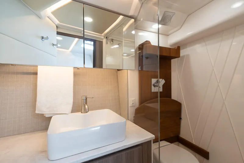 Slide: The Image of Luxurious bathroom in 2022 Regal 36 XO yacht with modern sink and shower. - 28