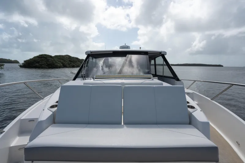 Slide: The Image of 2022 Regal 36 XO yacht on calm waters under cloudy sky. - 30