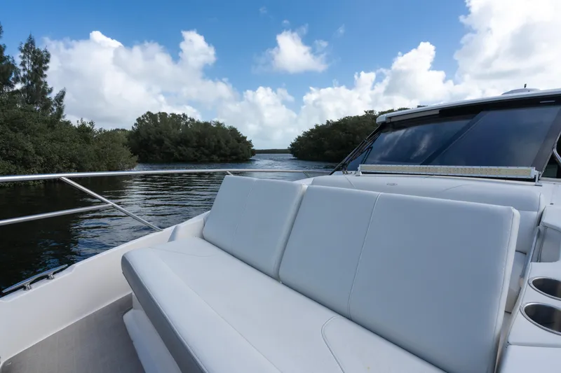 Slide: The Image of Regal 36 XO 2022 boat cruising on a scenic river with lush greenery. - 31