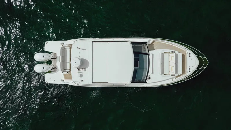 Slide: The Image of Aerial view of 2022 Regal 36 XO boat on dark green water. - 9