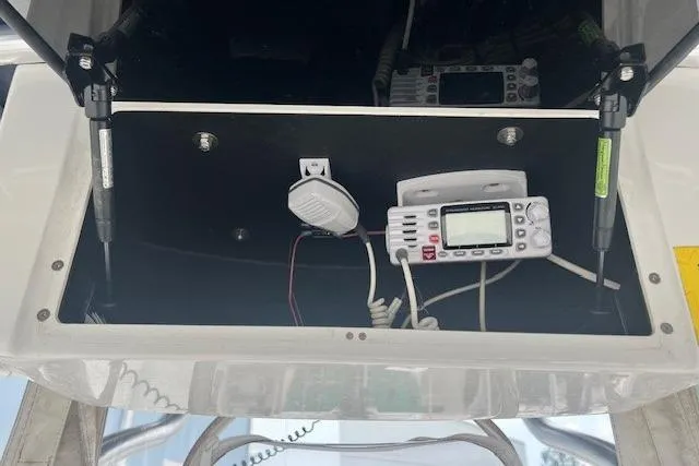 Slide: The Image of 2017 Robalo R200 Center Console boat electronics compartment with radio equipment. - 5