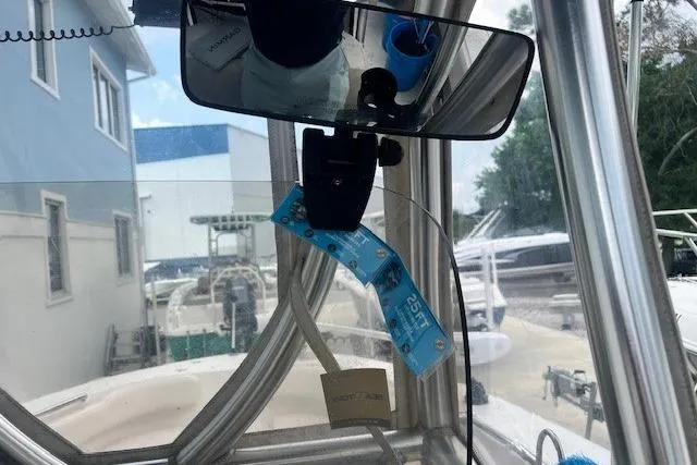 Slide: The Image of 2017 Robalo R200 Center Console interior view with rearview mirror and docked boats. - 6