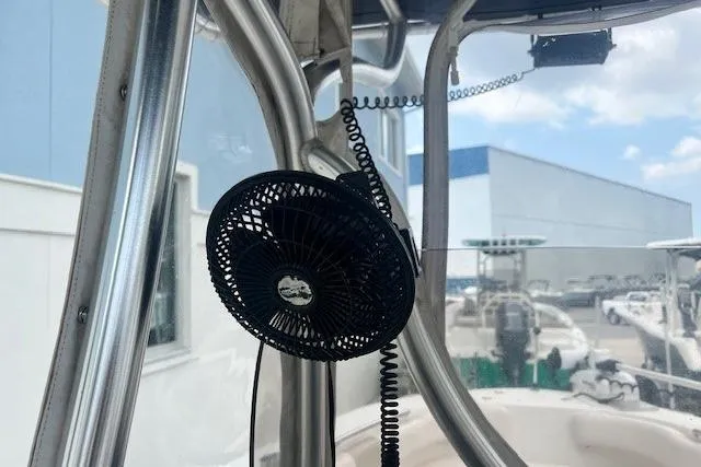 Slide: The Image of 2017 Robalo R200 Center Console boat with mounted fan and marina background. - 7