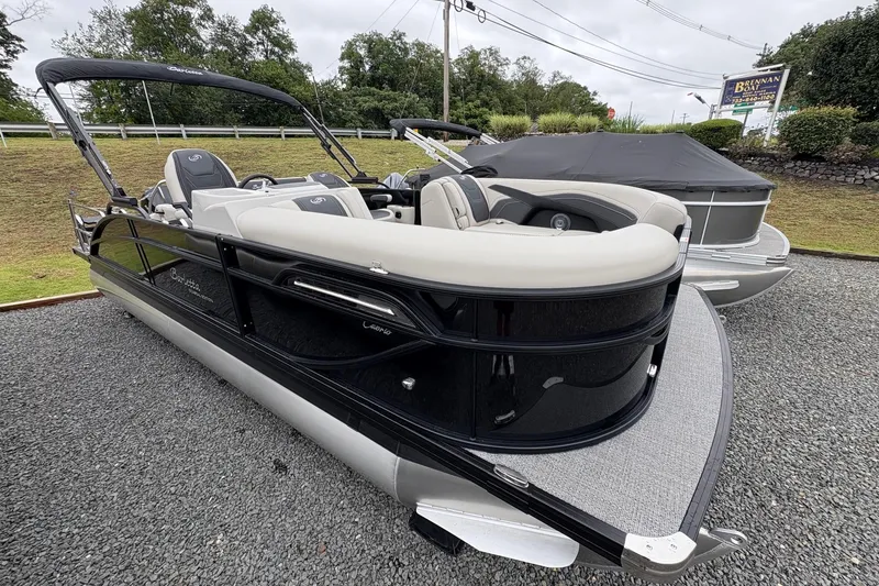 Slide: The Image of 2026 Barletta C22UC pontoon boat with sleek design on display outdoors. - 0