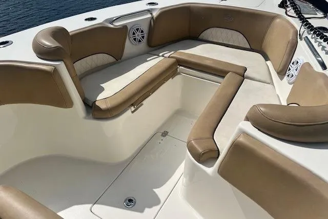 Slide: The Image of 2018 Key West 263 FS boat interior with tan seating and white accents. - 12