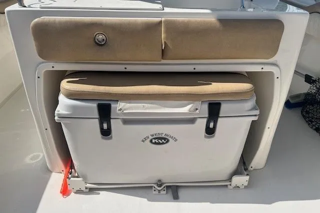 Slide: The Image of 2018 Key West 263 FS boat cooler with cushioned seat and storage compartment. - 15