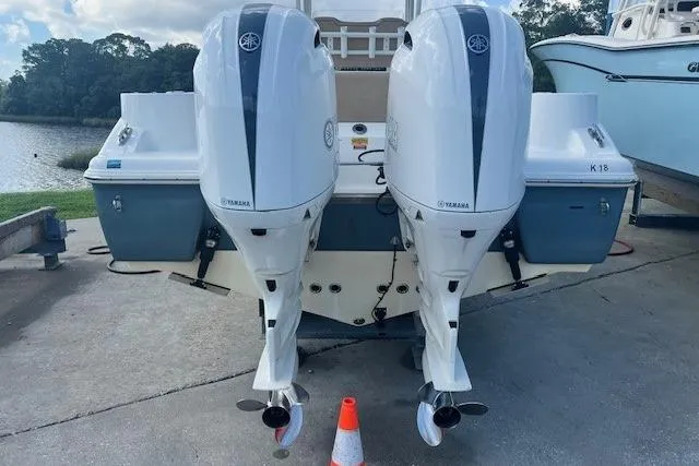 Slide: The Image of 2018 Key West 263 FS boat with dual Yamaha outboard engines, docked near a lake. - 3